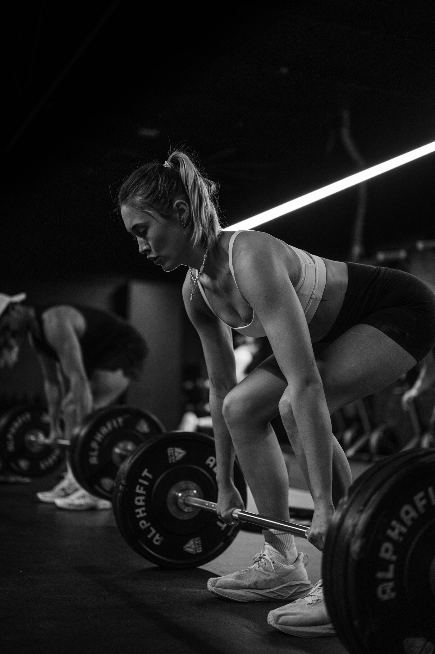 A member set up over the bar before a deadlift