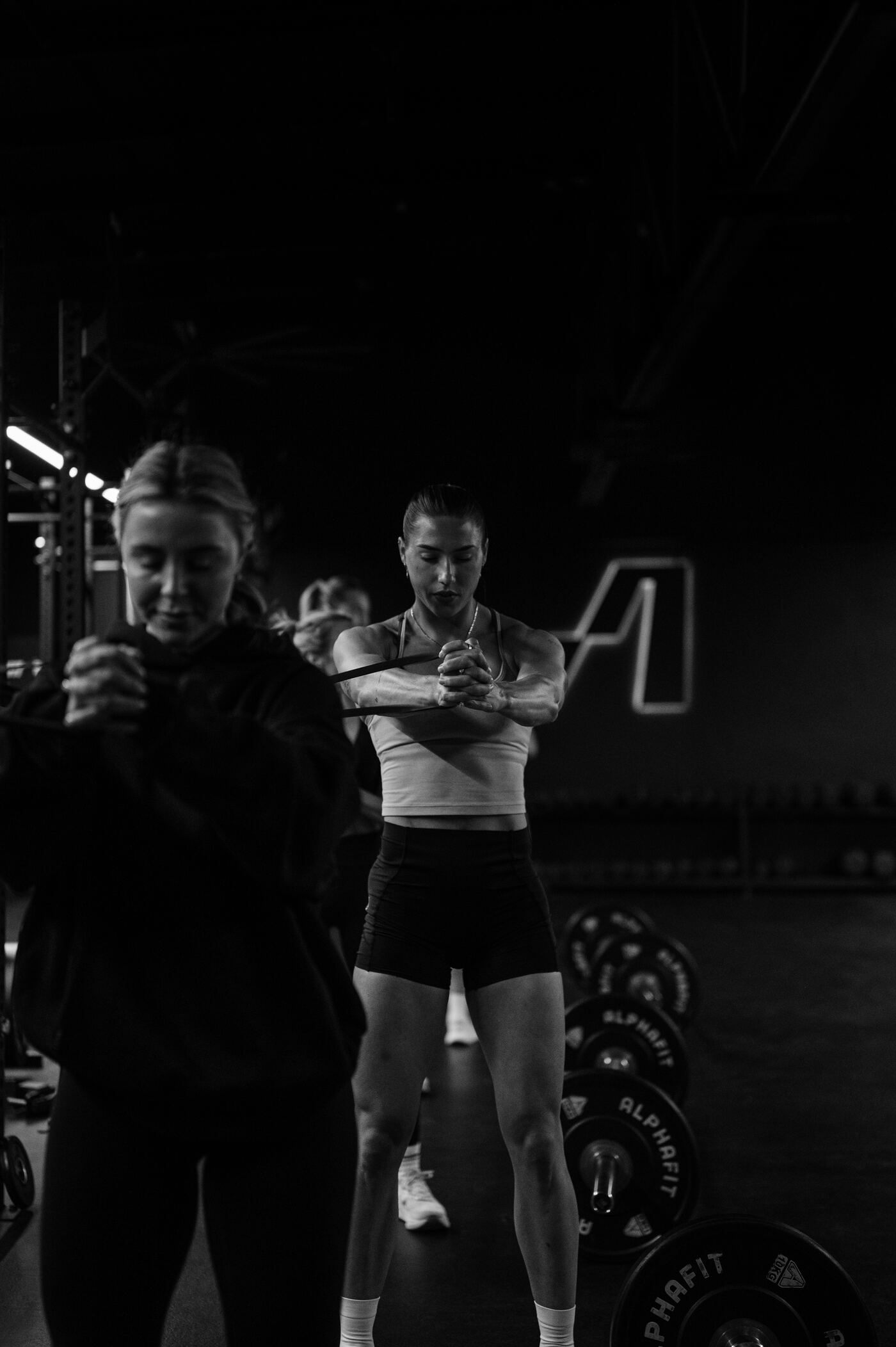 Two members working through a banded warm up