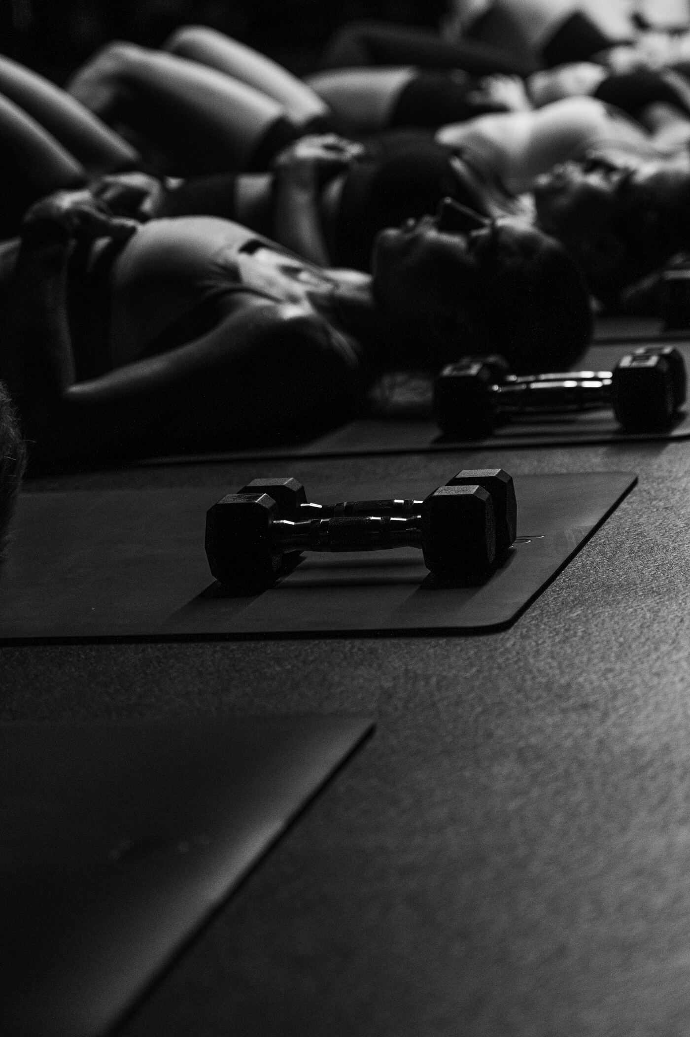 Dumbbells set out on a mat before class